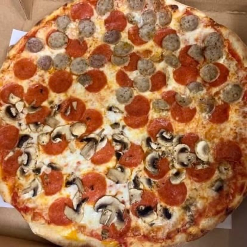 A Pizza Village V pizza with pepperoni, sausage, and mushrooms, half and half.